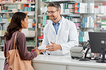 Pharmacist speaking to customer at pharmacy